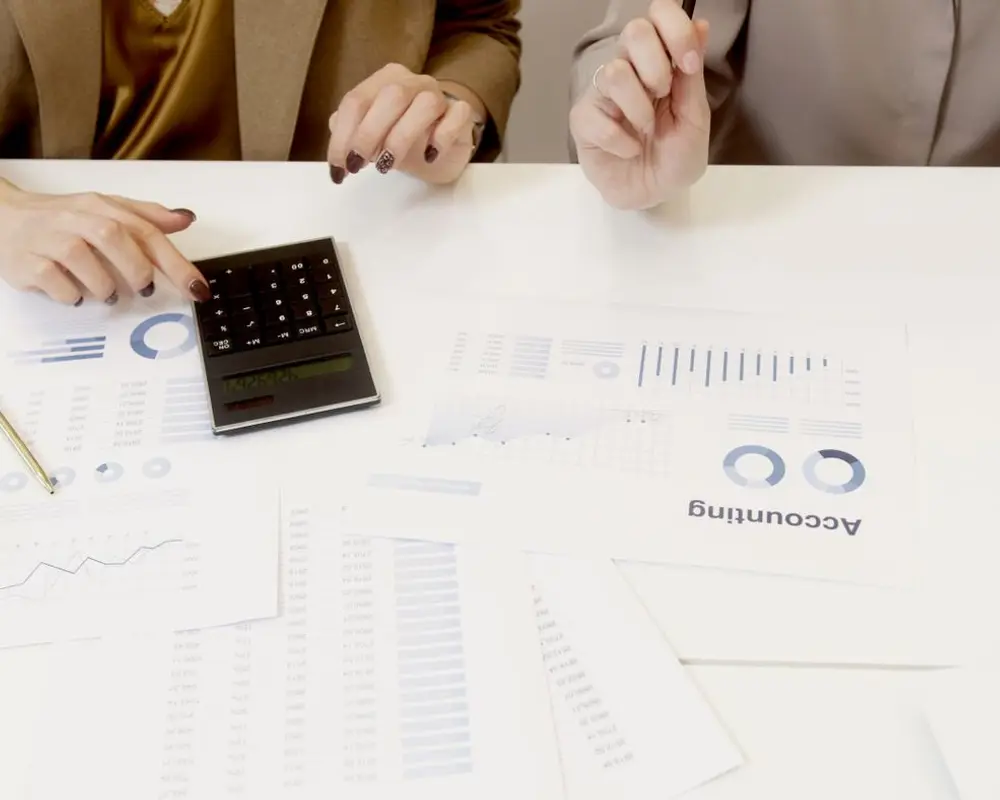 Accountant reviewing financial statements with a calculator